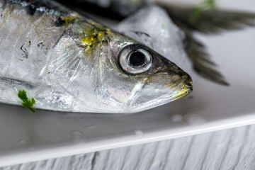 Fresh raw fish on wooden board. Background. From above