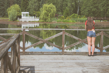 Young girl on a wooden bridge