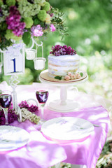 Rustic cake decorated with roses and violet lilac