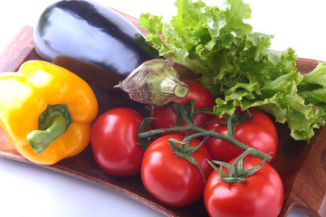 Fresh assorted vegetables, eggplant, bell pepper, tomato, garlic with leaf lettuce. Isolated on white background. Selective focus.