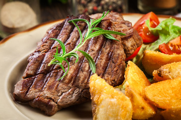 Succulent portions of grilled fillet mignon served with baked potatoes