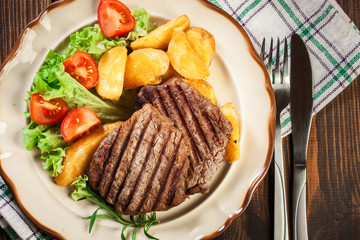 Succulent portions of grilled fillet mignon served with baked po