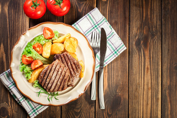 Succulent portions of grilled fillet mignon served with baked po