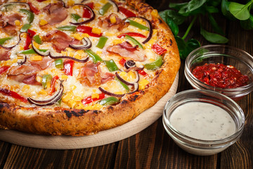 Homemade pizza with bacon, paprika and corn