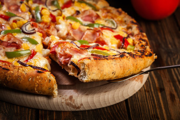 Homemade pizza with bacon, paprika and corn