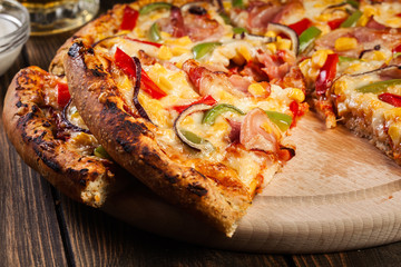 Homemade pizza with bacon, paprika and corn