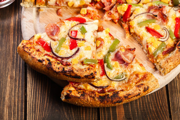 Homemade pizza with bacon, paprika and corn