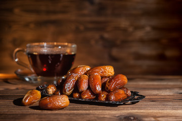 concept of  muslim feast holy month Ramadan Kareem with dates and cup of tea