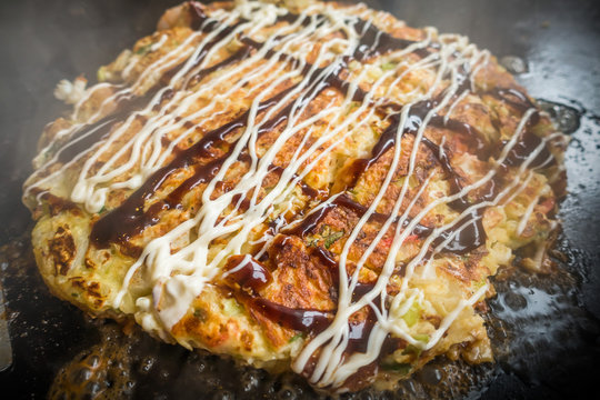 お好み焼き Okonomiyaki is a Japanese-style pancake
