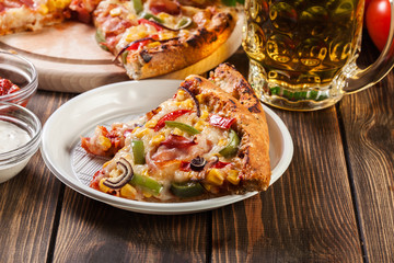 Slices of pizza with bacon, paprika and corn