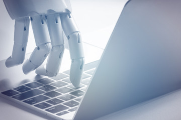 Chat bot , artificial intelligence , robo advisor , robotic concept. Robot finger point to laptop...