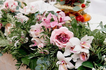 Wedding table decoration newlyweds. Songs on the table of flowers.The pink and white palette, rose, Orchid