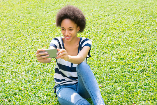 Young casual  afro woman taking selfie