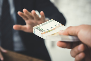 Businessman refusing money, South Korean won bills