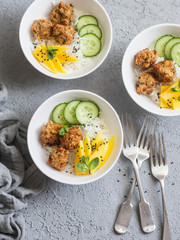 Crunchy fish balls, rice and mango on a grey background, top view. Delicious appetizer, tapas food