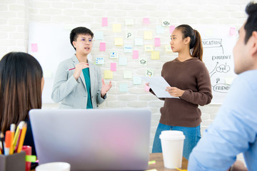 Group of students presenting and discussing project in classroom