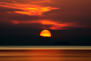 Fototapeta na wymiar Big sun and orange cloud in sunset sky on the lake.