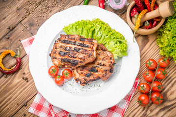 roasted chicken with herbs served on a plate  vegetables and grapes