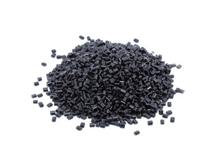 Black plastic polymer granules on white background