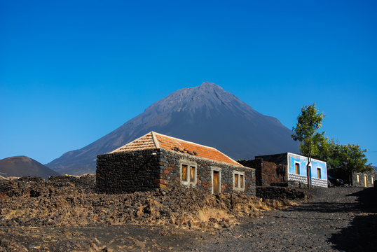 Cabo Verde, Pico do Fogo, Caldera. Volcano Pico do Fogo, 2829 m, the highest mountain of Cabo Verde standing isolated in the burned Lava fields. Hauses of igneous rocks in the Cha das Caldeiras