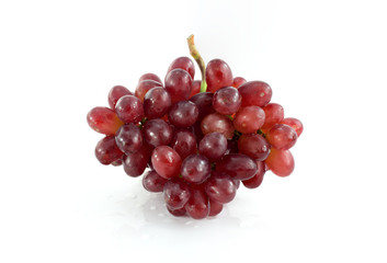 Ripe red grape. Pink bunch with leaves isolated on white. With clipping path. Full depth of field.
