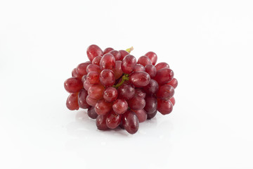 Ripe red grape. Pink bunch with leaves isolated on white. With clipping path. Full depth of field.