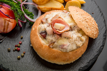 Vegetables and meat baked bun with ham, cheese  herbs.