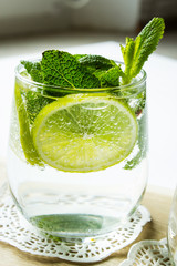 Clean drinking water with lemon, lime and mint. Selective focus.