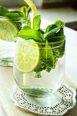 Clean drinking water with lemon, lime and mint. Selective focus.