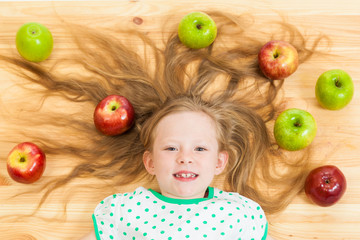 Fototapeta na wymiar the little girl among apples
