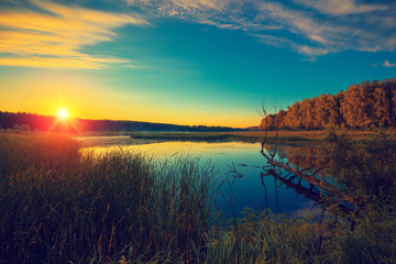 Fototapeta na wymiar Magical sunrise over the lake. Misty morning, rural landscape, wilderness, mystical feeling