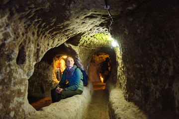 Fototapeta na wymiar man exploring caves in Kaymakli underground city