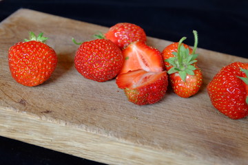 fresh strawberries on a wooden cutting board