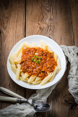 Pasta penne with tomato bolognese sauce.