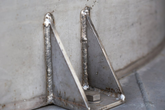 Stained steel plate with weld seam, industrial background texture