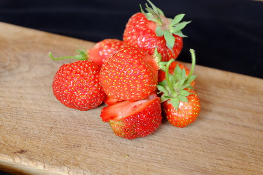 fresh strawberries on a wooden cutting board