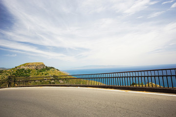 Obraz premium Mountain road to a small Sicilian village Castelmola with a panoramic view of mediterranean sea and mainland Italy.