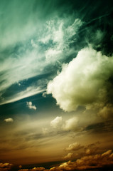 Obraz premium Fog and clouds looking up into a fantasy evening sky. Image looks antique, In orange and green colors