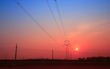 Fototapeta na wymiar High piezoelectric towers, in the setting sun