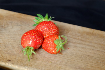 fresh strawberries on a wooden cutting board