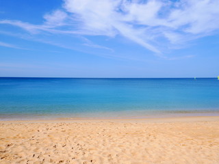 Empty beach with bright blue sky on Phuket Island