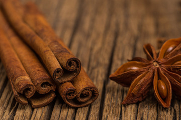 Star anise and cinnamon on old wooden table.