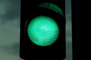 Night close up image of green traffic light. With film grain/noise.