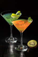 Kiwi and orange jelly with lime pieces in the glasses topped mint leaves