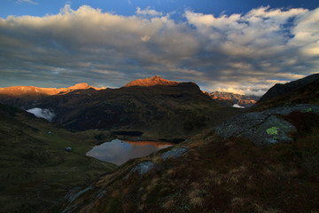 Colorful sunset over mountains and lake