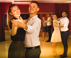 People learning to dance waltz in dancing class