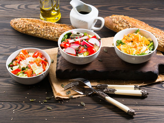 Colorful vegetable salad bowl for lunch on wooden rustic background