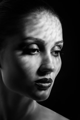 happy luxury woman model with professional makeup on black background, monochrome