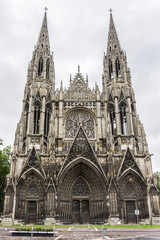 Fototapeta premium Saint-Ouen Abbey Church (Abbatiale Saint-Ouen, 1318 - 1537) is a large Gothic Roman Catholic church in Rouen, Normandy, France. Western facade with two spire-towers.