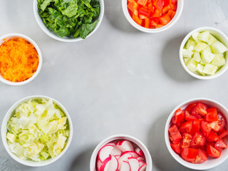 Mix of vegetable bowls for salad or snacks on gray background. Diet detox concept